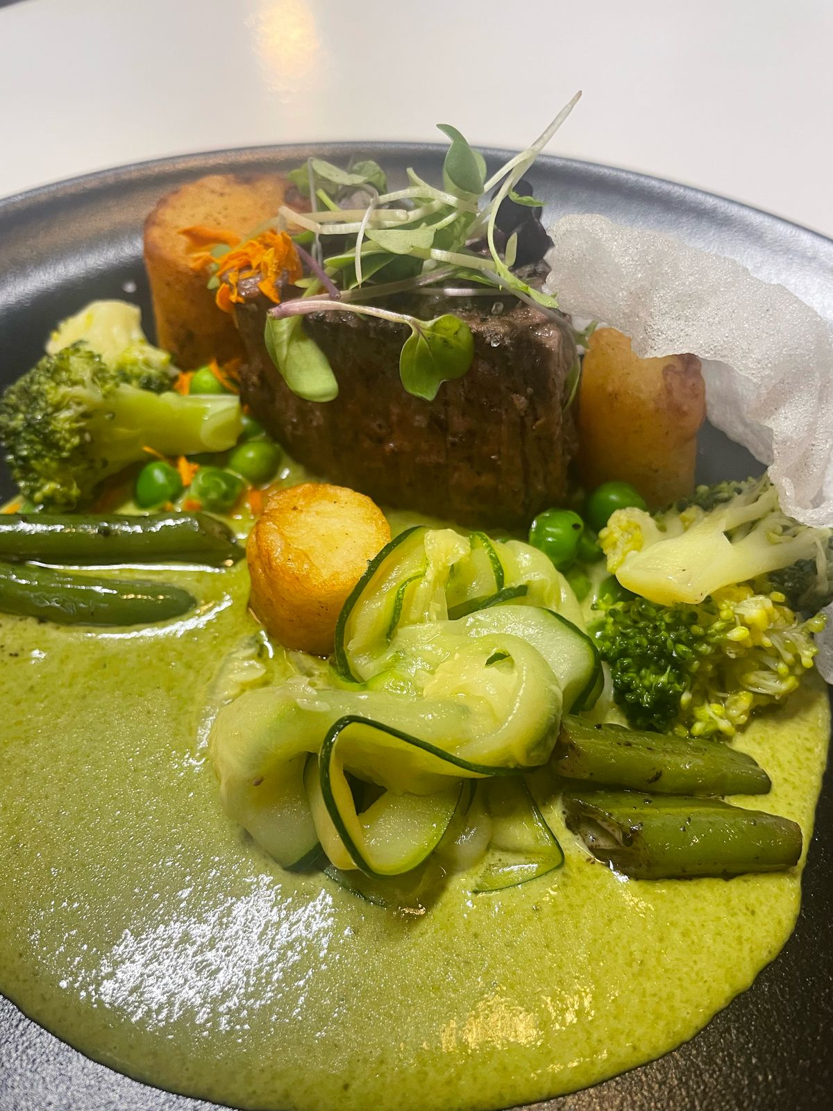 Beef with green sauce and vegetables