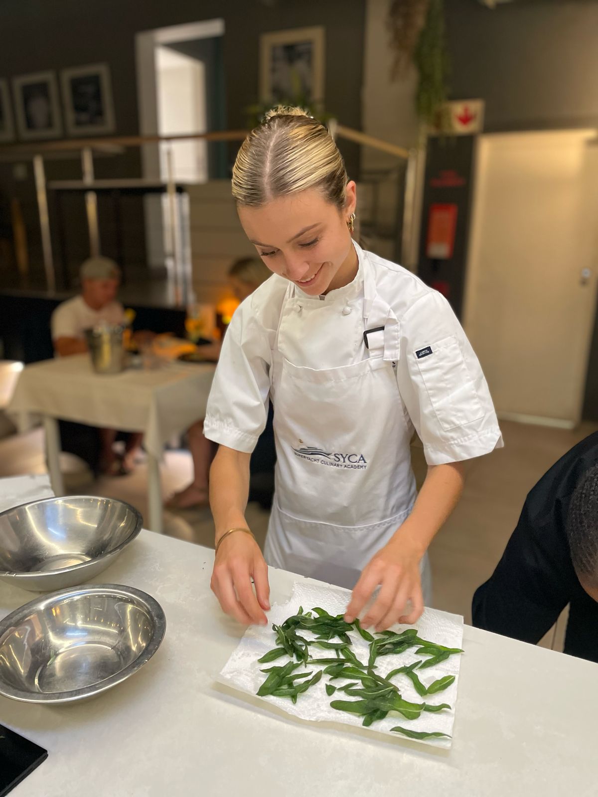 Aeron Osmond preparing herbs in professional kitchen